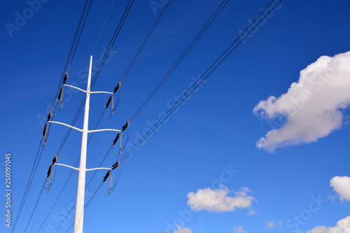 Power Lines across Blue Sky and Clouds