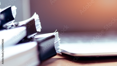 Stack of documents placed on a business desk in a business office.