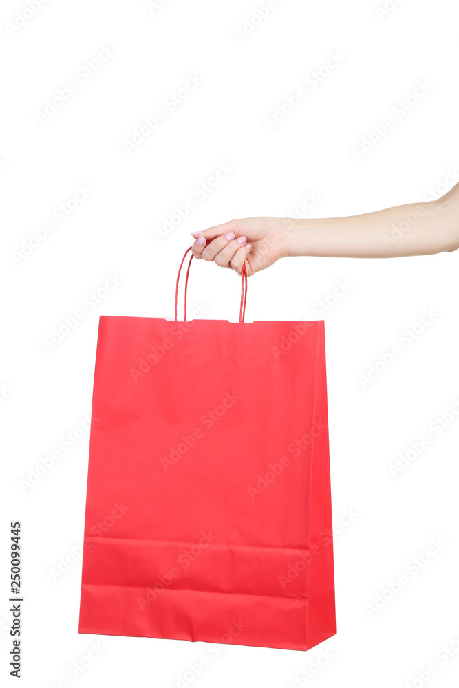 Female hand holding red shopping bag on white background