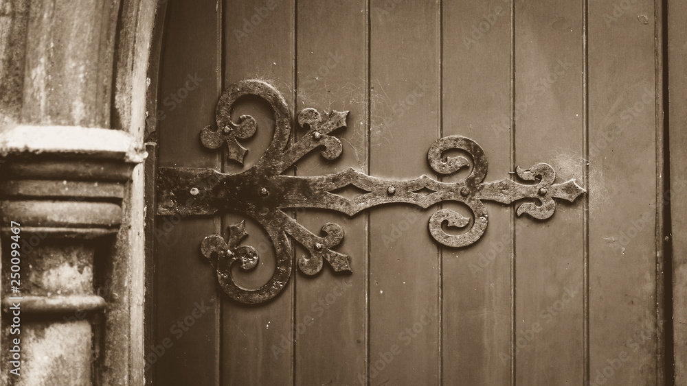 Decorative Ironwork on Wooden Door in Sepia Tone Decorative Ironwork on Wooden Door in Sepia Tone