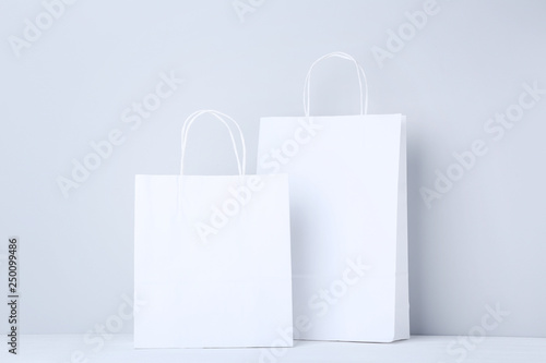 White shopping bags on grey background