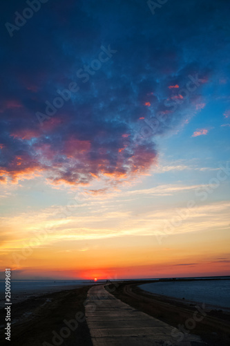 Beautiful natural textural background of the sunset on the lake  river. Salt lake Elton  Russia  sunset on the water
