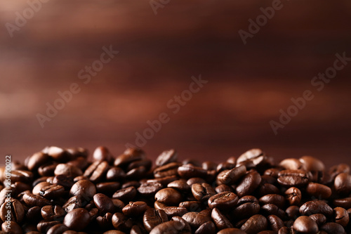 Coffee beans on brown background