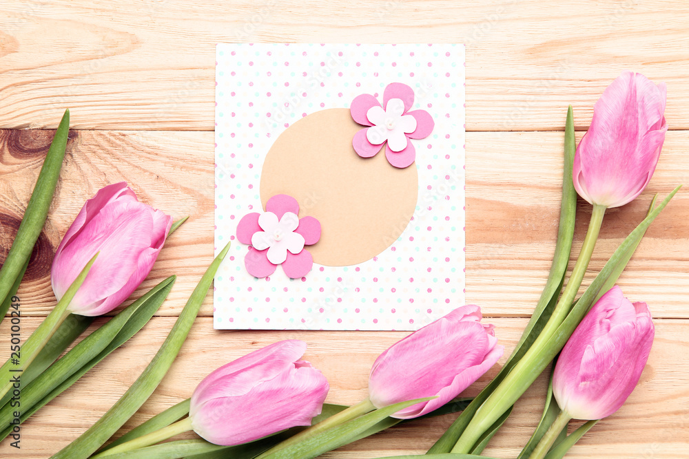 Greeting card with pink tulip flowers on wooden table Greeting card with pink tulip flowers on wooden table