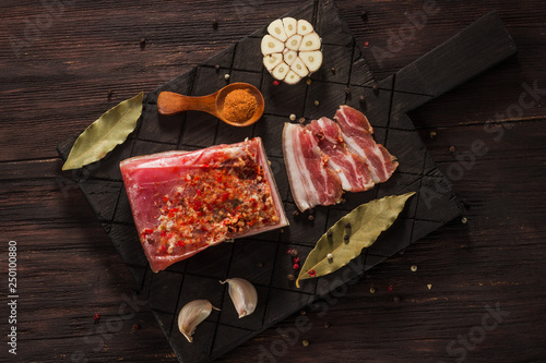 Salted dried bacon with spices and bay leaves and garlic