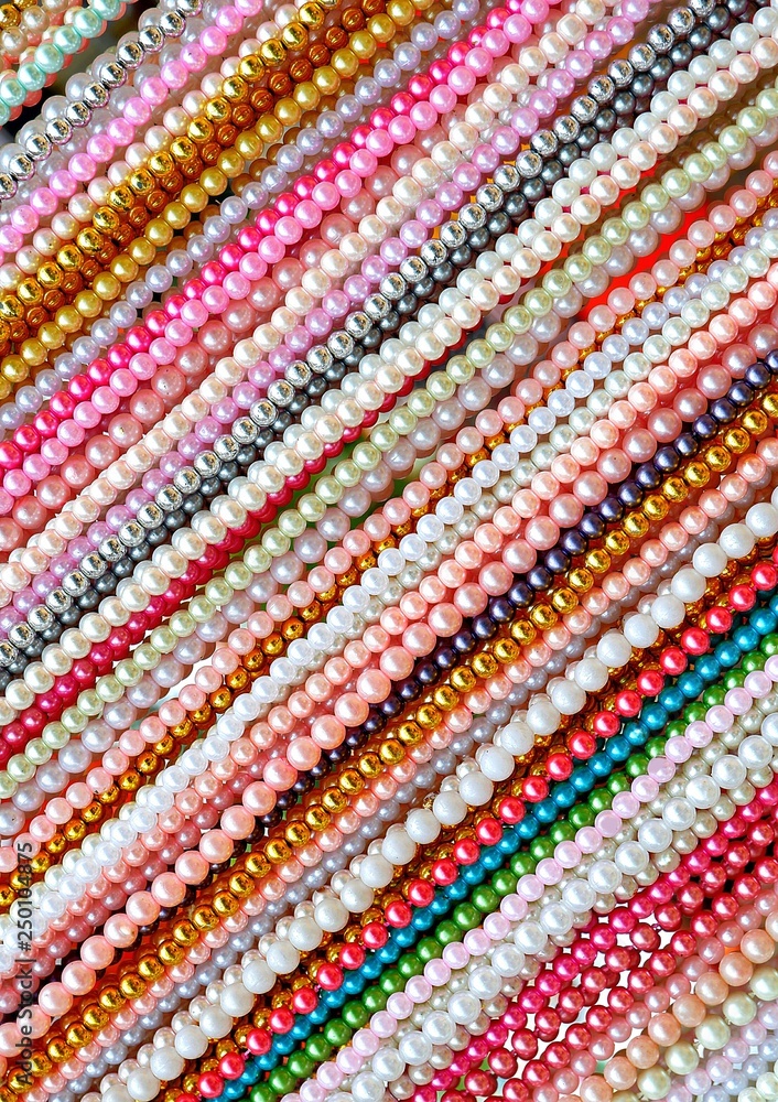 Diagonal lines pattern of multicolored bead necklace accessories in vertical frame on ornaments background decoration design concept