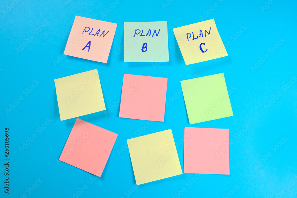 Many colored empty office stickers on a blue background and three separately with plan A plfn B and plan C . Mock-up Many colored empty office stickers on a blue background and three separately with plan A plfn B and plan C . Mock-up