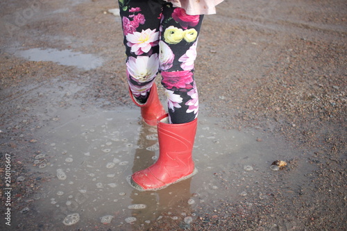 A child walking in a puddle