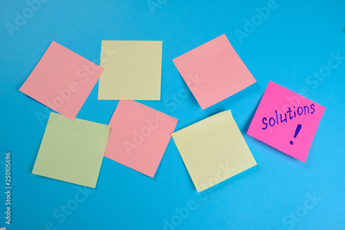  Many colored empty office stickers on a blue background and one separately . Mock-up