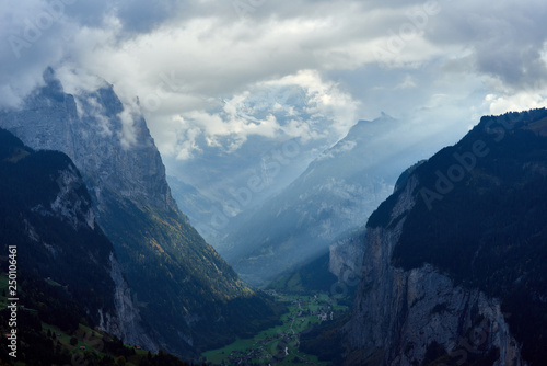 Impressive scenery of the mountain valley with peaks covered by the clouds. Near Wengen village in Switzerland.