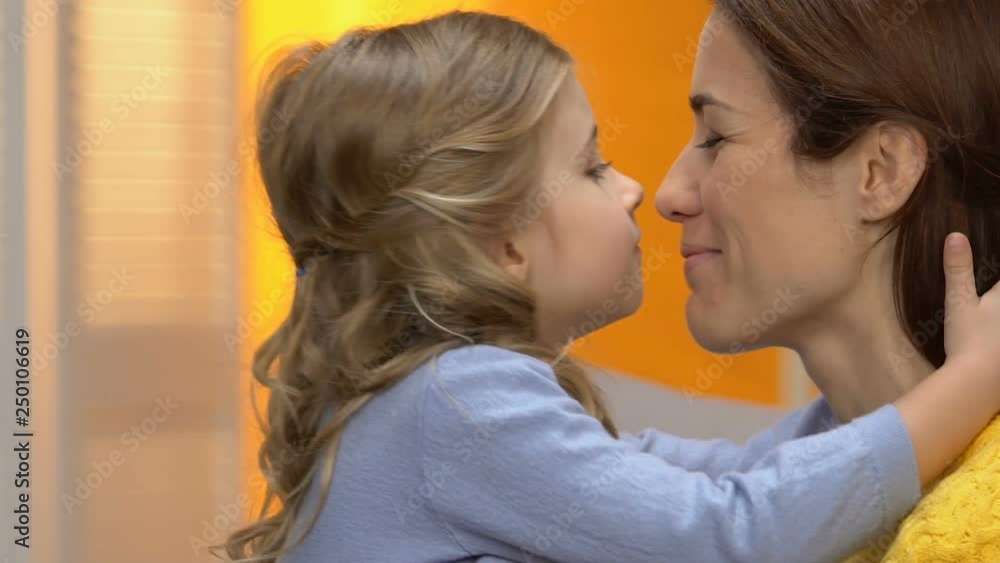 Adorable funny little girl hugging mother and starting nuzzling, happy family Adorable funny little girl hugging mother and starting nuzzling, happy family