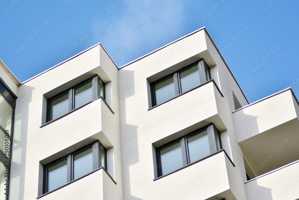 Modern white building with balcony on a blue sky Modern white building with balcony on a blue sky