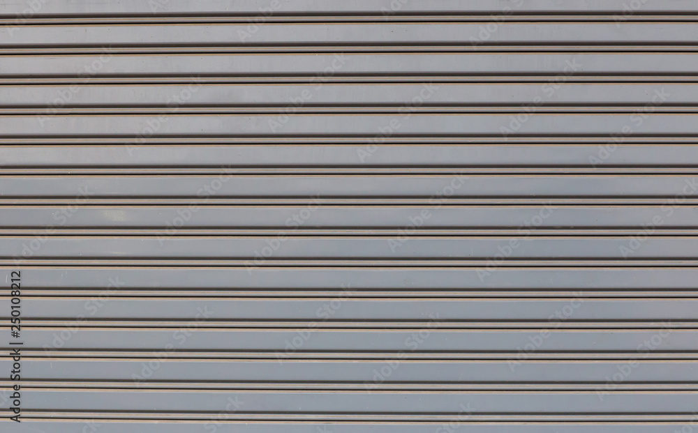 steel rolling door of shop or store, front view. The garage door has