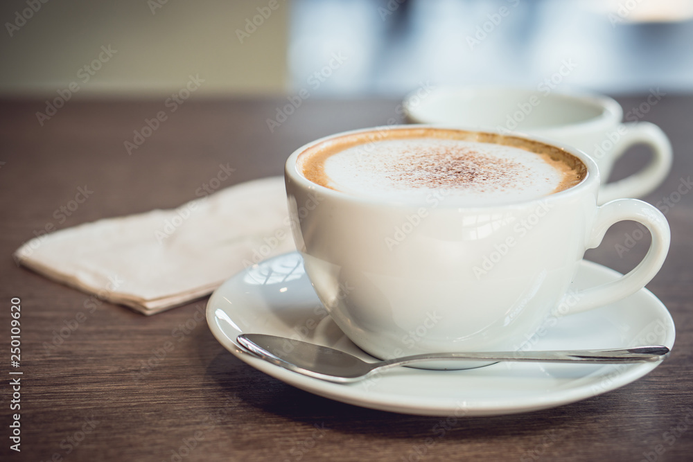 Hot coffee and hot tea place on the wooden table in early morning with copyspace, white cup and silver spoon. Hot coffee and hot tea place on the wooden table in early morning with copyspace, white cup and silver spoon.