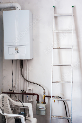 Modern home gas boiler, water heater. Renovation and aluminum construction stairs photo