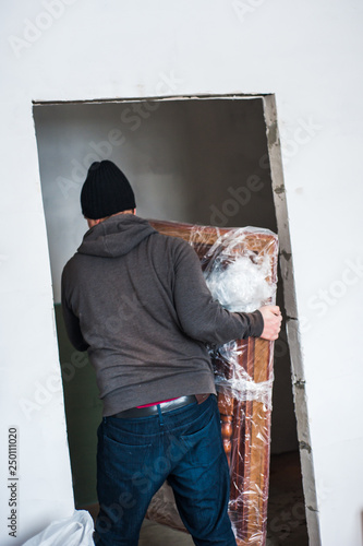 The worker takes out things from the repaired premises.