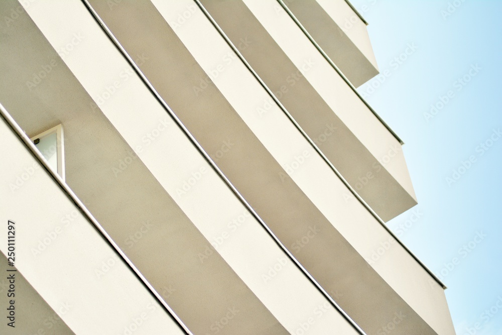 Obraz premium Modern white building with balcony on a blue sky