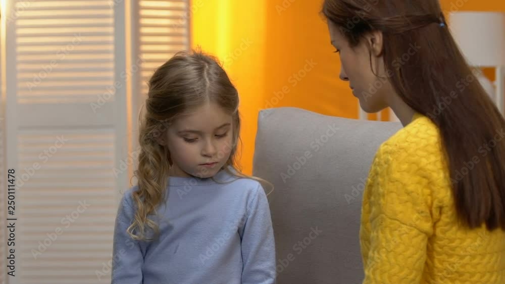 Female hugging and comforting little shy adopted girl, life in family beginning Female hugging and comforting little shy adopted girl, life in family beginning