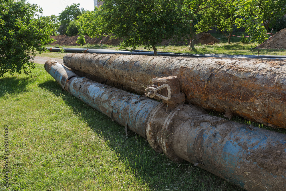 Fragments of old large water pipes. After many years of operation, corroded metal pipe destroyed. Rusty steel tube with holes metal corrosion. Selective focus. Fragments of old large water pipes. After many years of operation, corroded metal pipe destroyed. Rusty steel tube with holes metal corrosion. Selective focus.