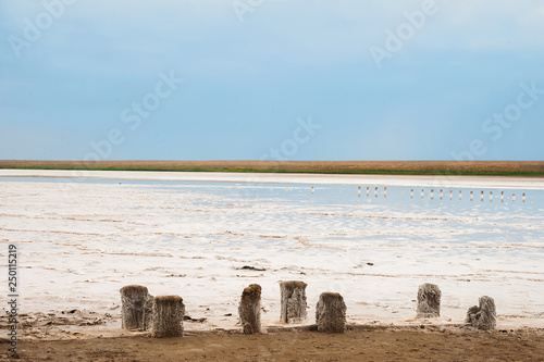 Beautiful natural textural background on a salt lake, river. Salt lake Elton, Russia, before rain and thunder, sunset on the water, solitude, silence, calm
