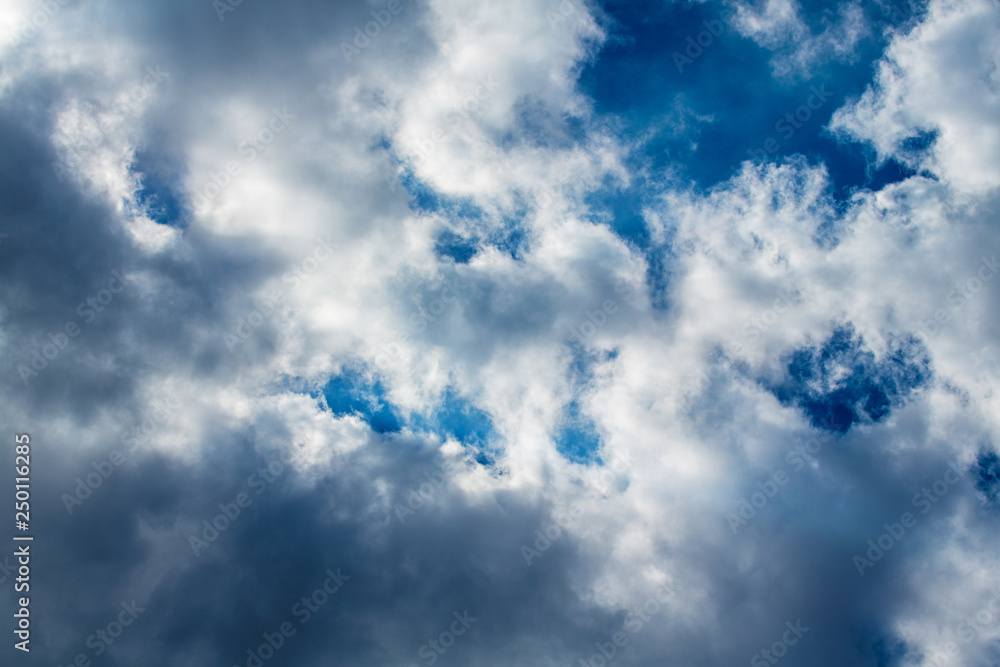 White and gray clouds against blue sky. Coulds start to form a storm in sunny day. White and gray clouds against blue sky. Coulds start to form a storm in sunny day.