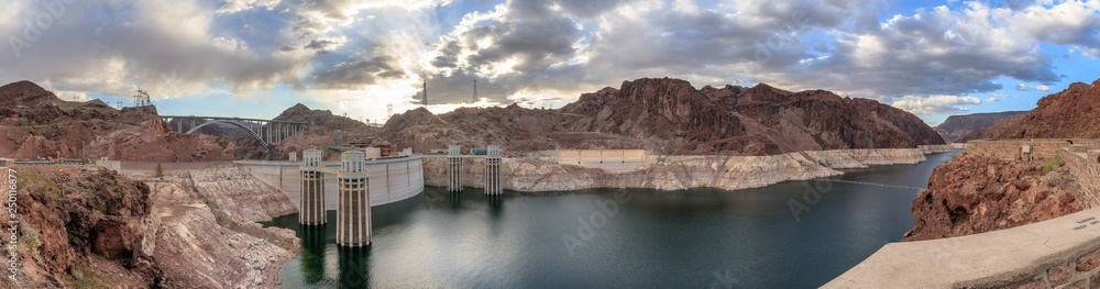 Panorama view of Hoover Dam. It is a concrete arch-gravity dam in the Black Canyon of the Colorado River, on the border between the U.S. states of Nevada and Arizona. It is Hydroelectric power station