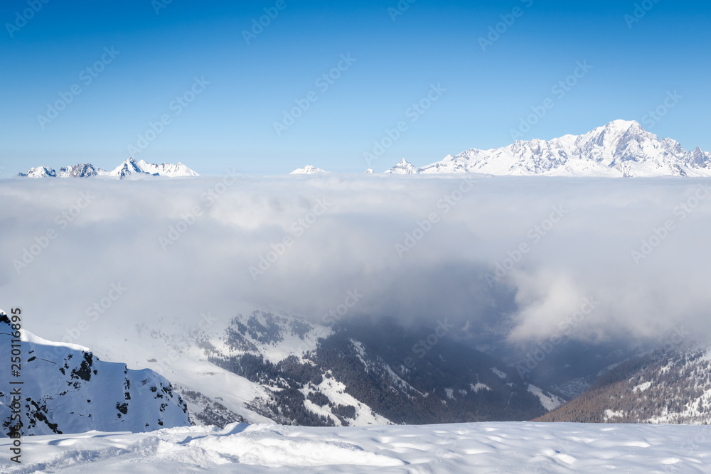 Mont Blanc mountain above the clouds. View from ski resort La Plagne in Savoy Alps, France
