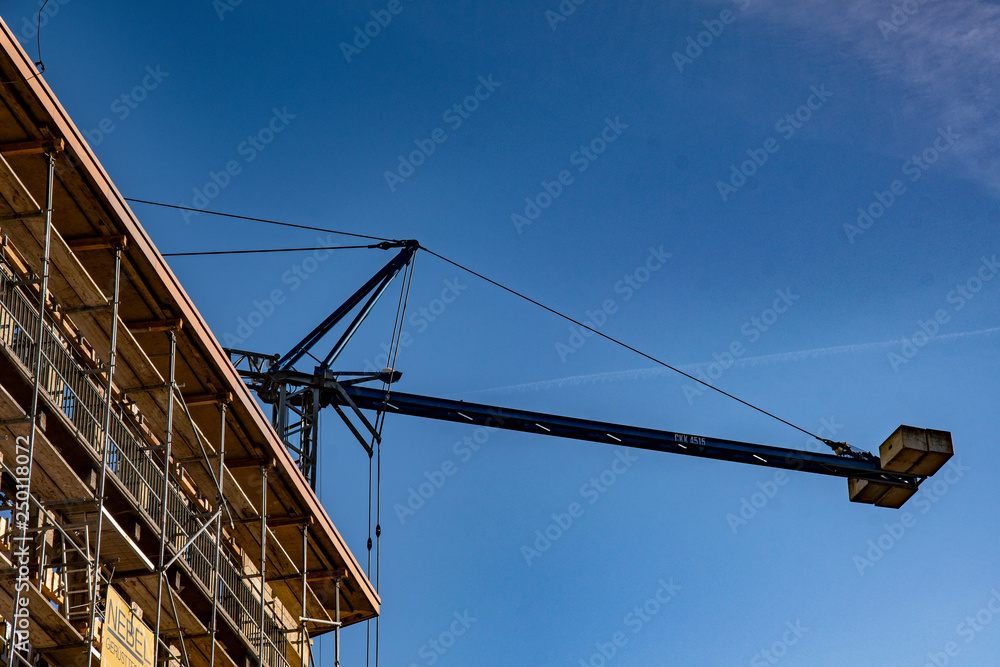 scaffolded house with a crane