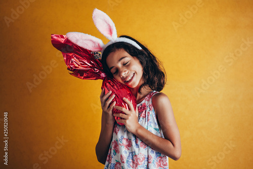 Photography Cute little child wearing bunny ears on Easter day on color background