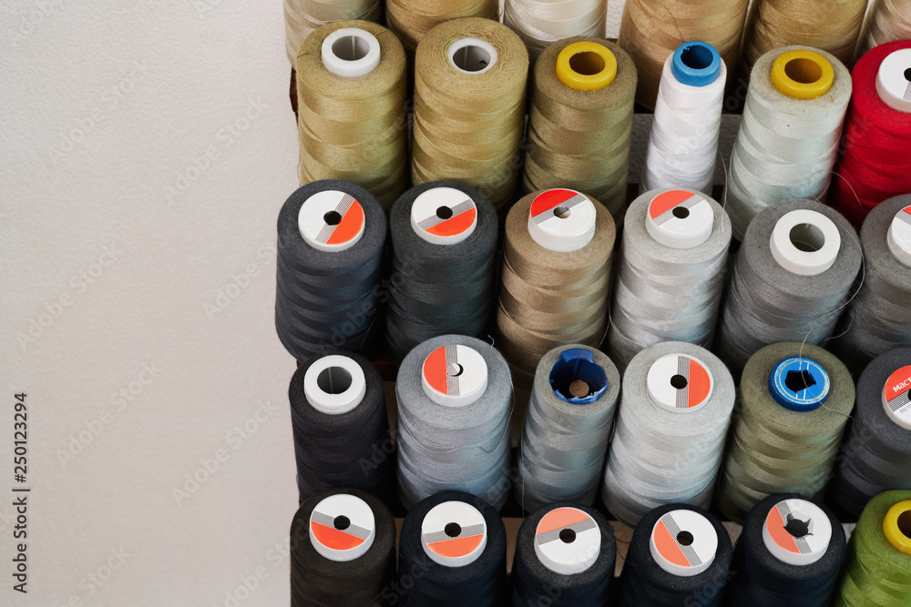 Fototapeta premium Spools of thread on a stand in a sewing workshop.