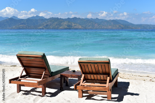 Sun umbrella with chair longue on the tropical beach in Gili Trawangan Island  Lombok  Indonesia