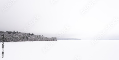 Ashokan Reservoir, Tourist Destination in Upstate NY. Part of the NYC Water Supply. Winter Scene During a Snowstorm. Snow covered Reservoir and Trees in Whiteout Conditions. Tranquil Panorama.