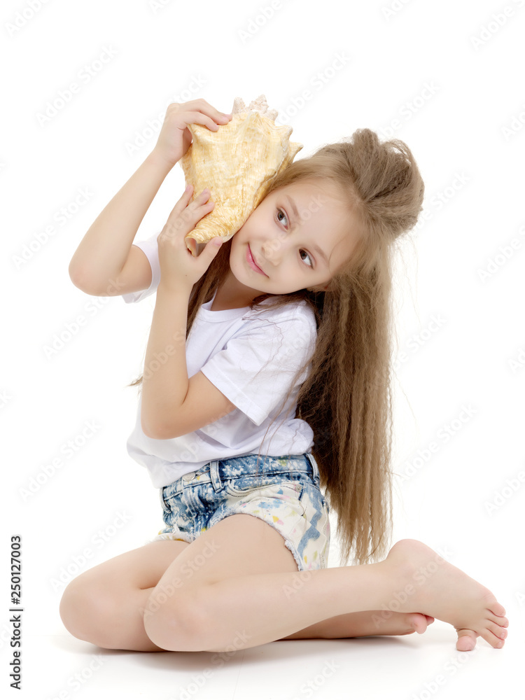 Little girl with sea shell