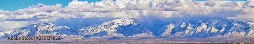 Winter Panoramic view of Snow capped Wasatch Front Rocky Mountains, Great Salt Lake Valley and Cloudscape from the Bacchus Highway. Utah, USA. © Jeremy