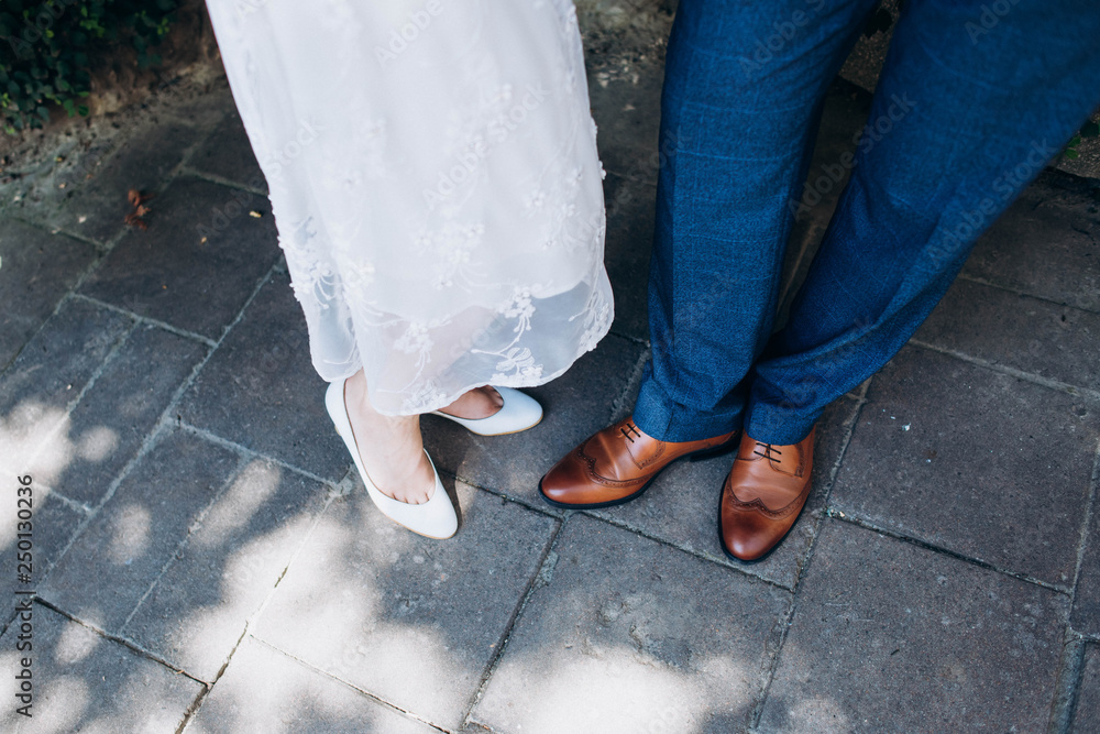 Bride white and groom brown shoes in retro style Bride white and groom brown shoes in retro style