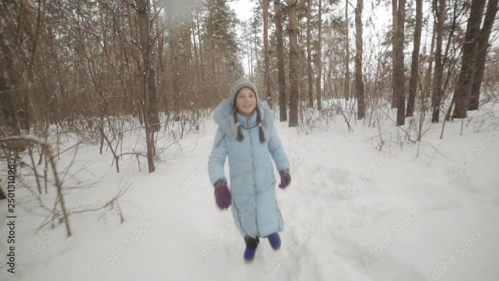 cheerful girl running in the Park in winter cheerful girl running in the Park in winter