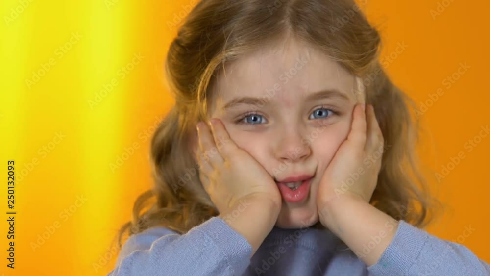 Playful little girl making funny face to camera, happy childhood, preschooler Playful little girl making funny face to camera, happy childhood, preschooler