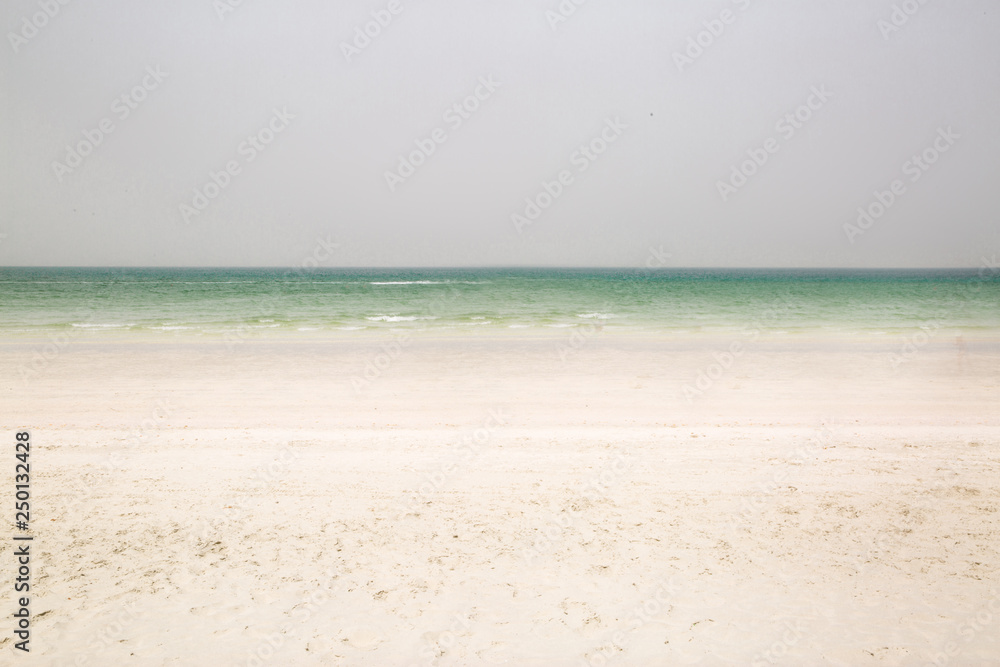 White sand beach and green ocean. Space for text, copy space. Vacation concept. 
