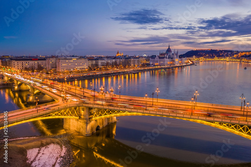 Budapest, Hungary - Aerial view of blue hour at Margaret Bridge by the entrance to Margaret Island with Parliament of Hungary and Szechenyi Chain Bridge at background
