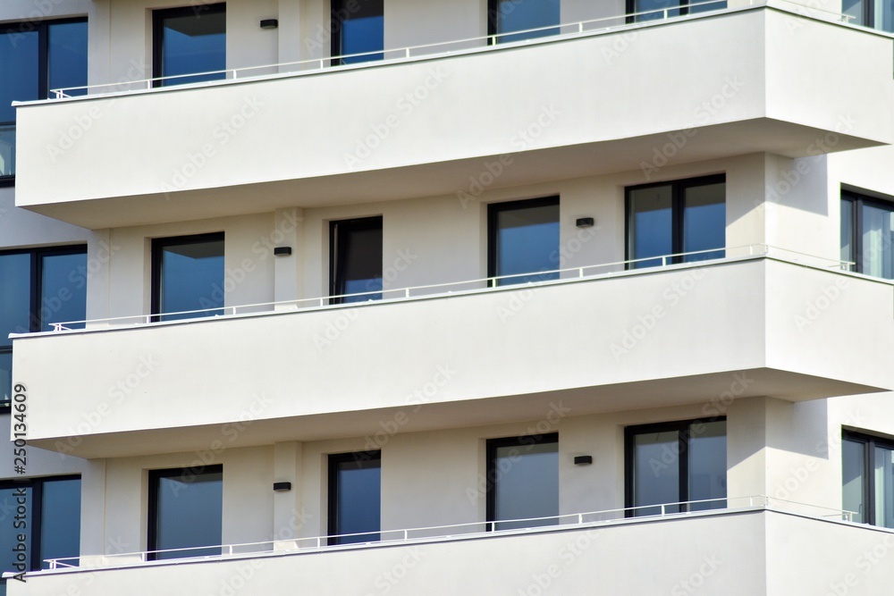 Modern white building with balcony on a blue sky Modern white building with balcony on a blue sky