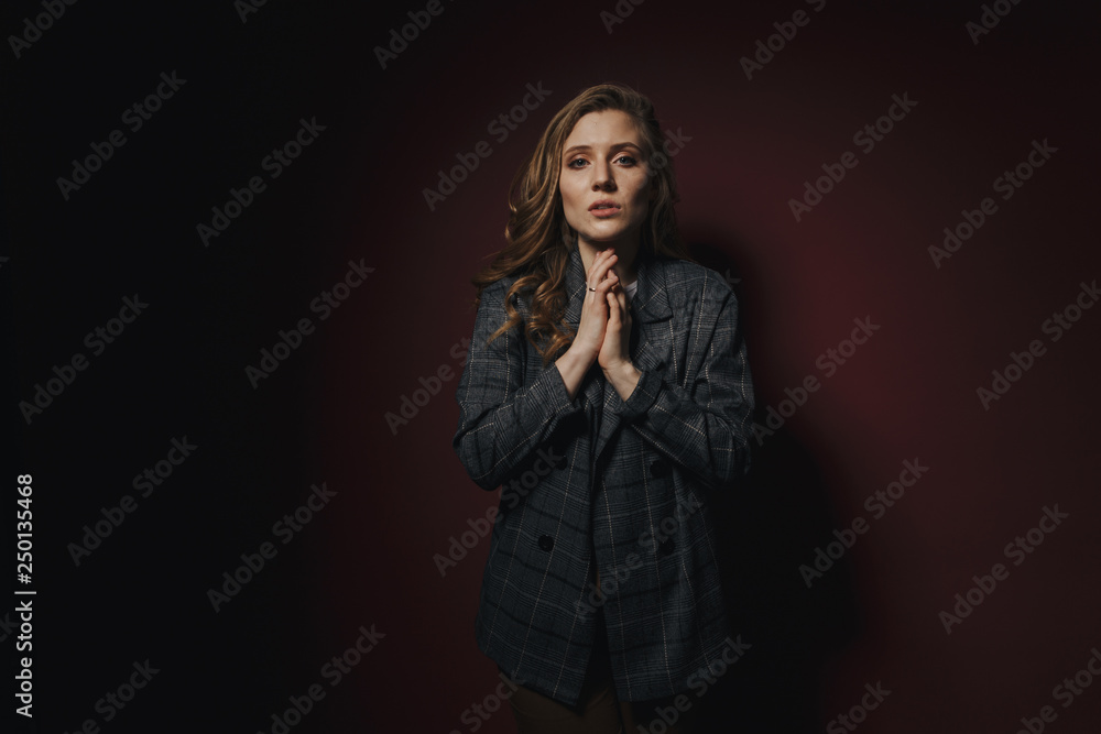 Sad young woman asking for something and looking so tired staying isolated over the dark pink background Sad young woman asking for something and looking so tired staying isolated over the dark pink background