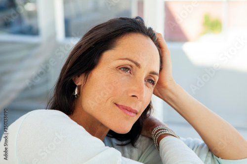 woman looking away - beautiful pensive middle aged person - close up portrait