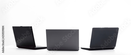 three open laptop in the workplace .isolated on white