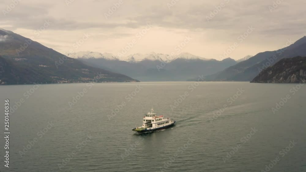 Aerial view of single ferry boat crossing Lago di Como, Cadenabbia, Italy. Aerial view of single ferry boat crossing Lago di Como, Cadenabbia, Italy.
