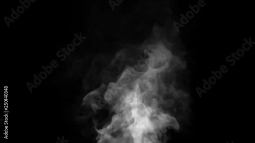 White steam spins and rises from the pan. White smoke rises from a large pot, which is located behind the frame. Isolated black background. photo