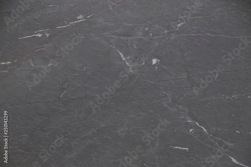 Closeup black soapstone stone with natural pattern texture background.