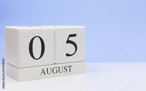 August 05st. Day 5 of month, daily calendar on white table with reflection, with light blue background. Summer time, empty space for text © Egor