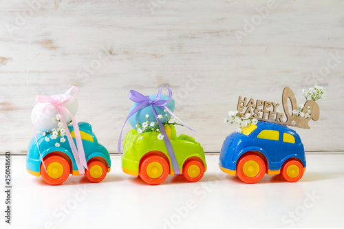 Two Easter cars with an egg and a car with the inscription 