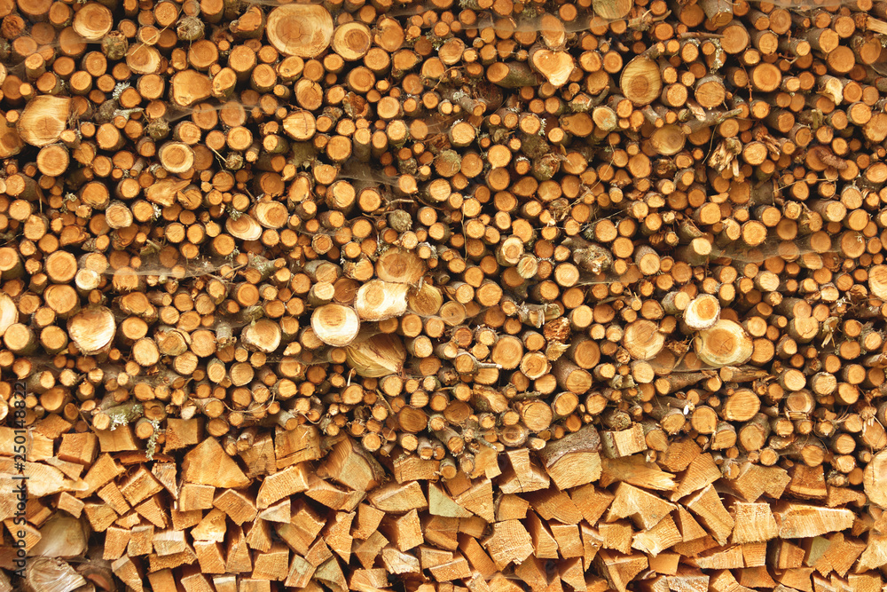 Chopped firewood background. Stacked firewood close up. Natural wooden background.