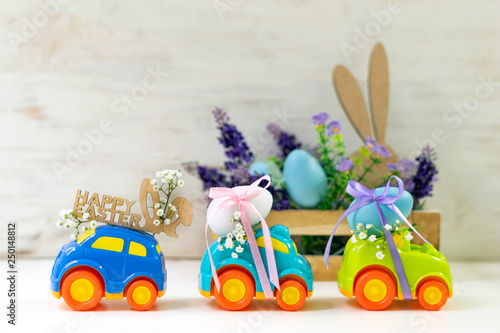 Two Easter cars with an egg and a car with the inscription 